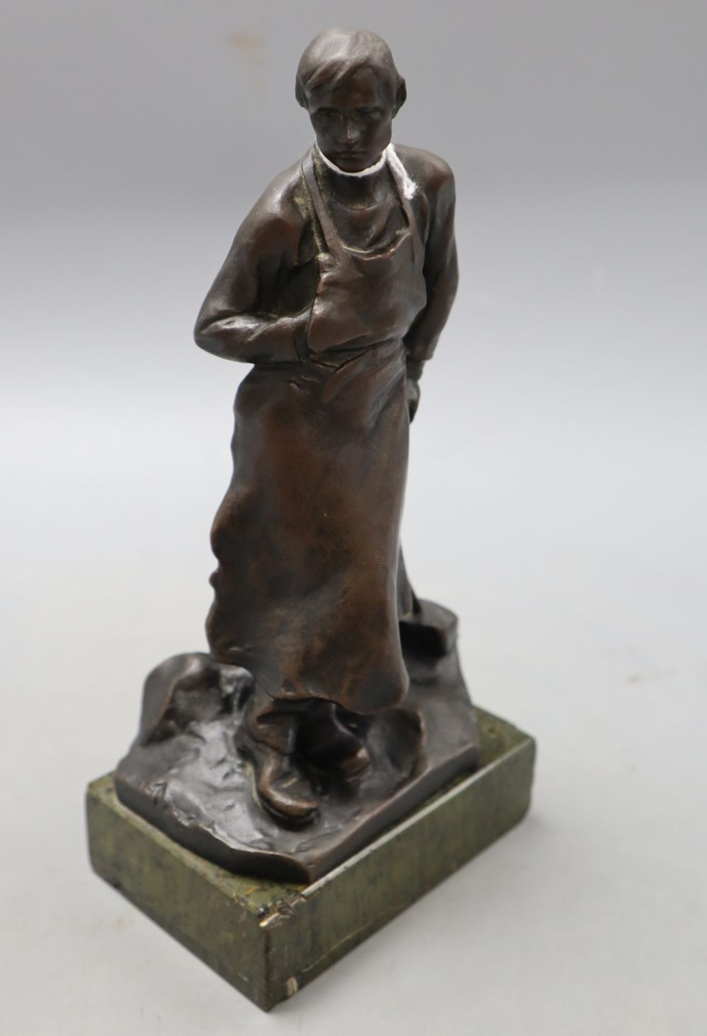 A bronze of a blacksmith, signed, height 22.5cm